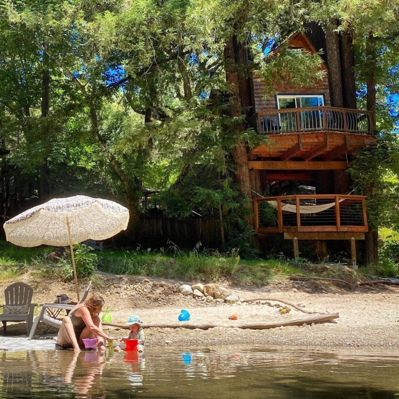 Anne and Harper in the creek beneath the Starlight Grove treehouse, 2020
