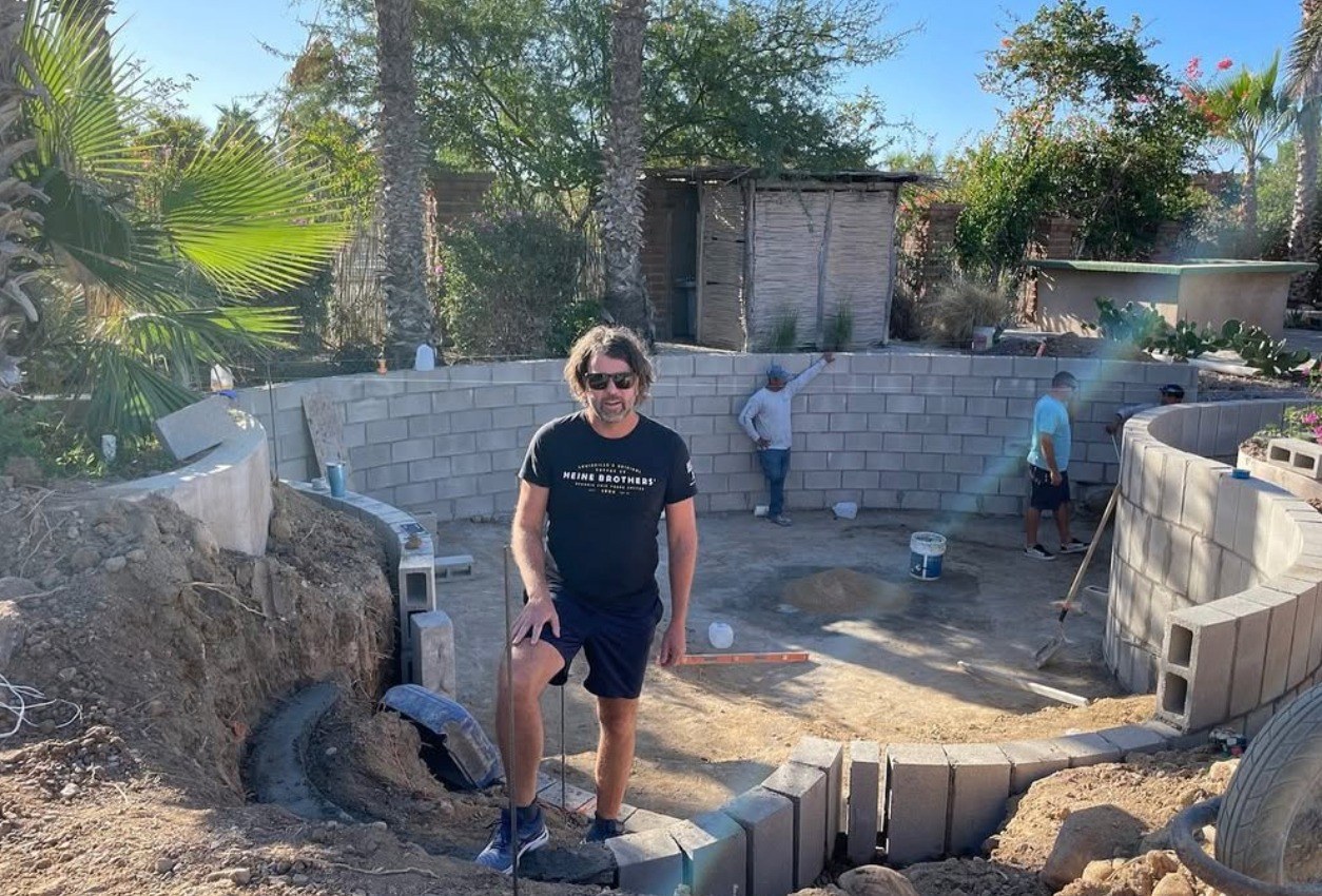 Chris standing in the pool excavation at Casa del Arte with the construction team